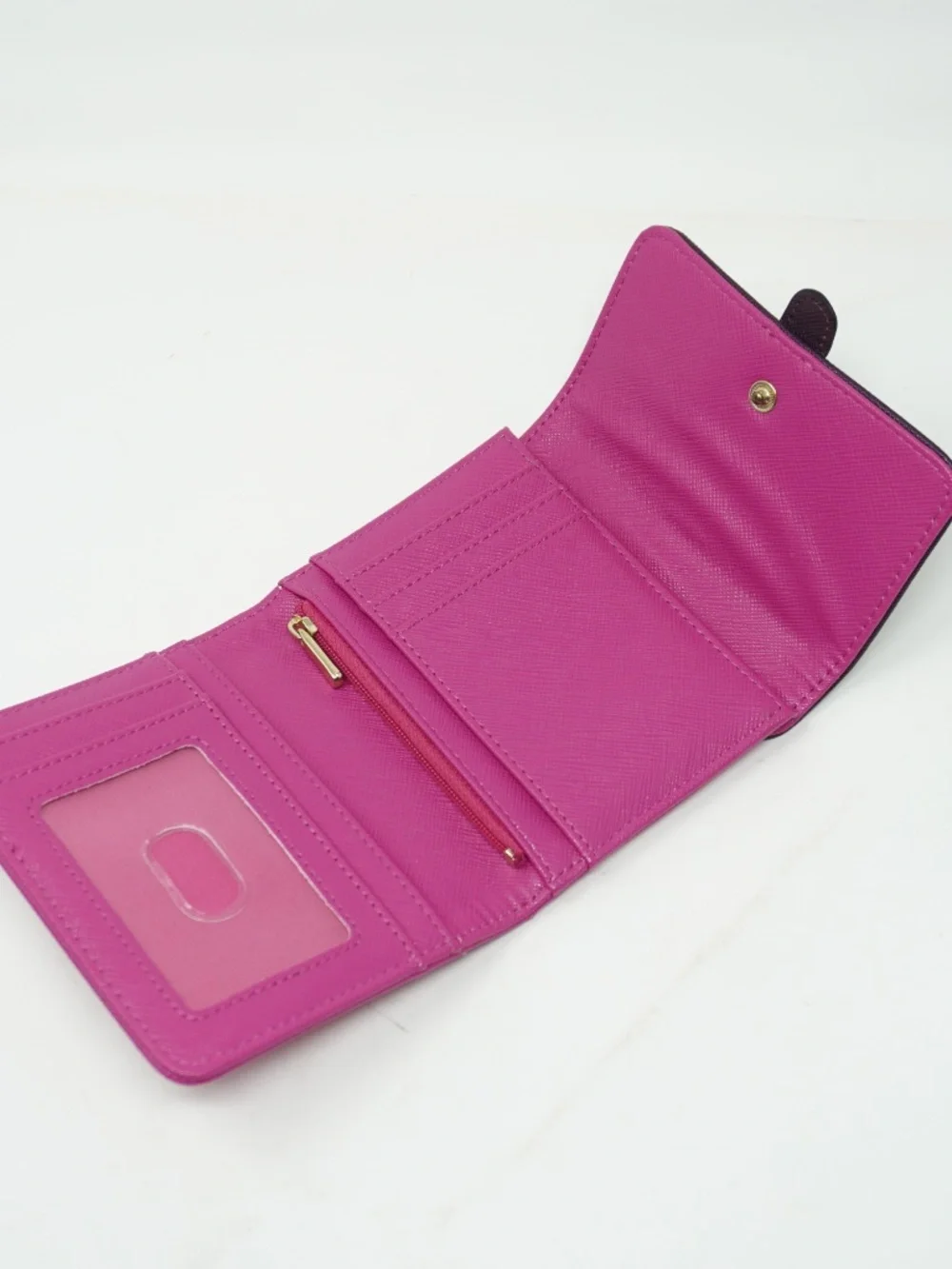 Cute small purple and pink bifold wallet features a textured finish